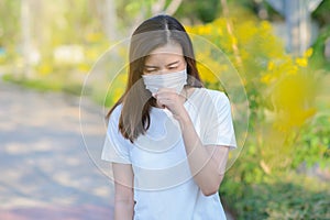 Asian woman suffer from cough with face mask protection