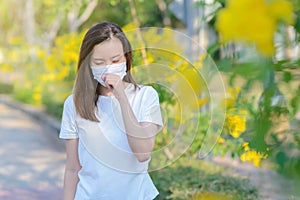 Asian woman suffer from cough with face mask protection