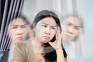 Asian woman suffering from dizziness hand holding her headache photo