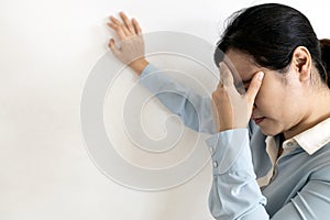 Asian woman suffering from dizziness,sensation of spinning around,losing her balance,Tired business woman touching her temple with