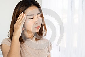 Asian woman suffering from headache, nausea ,dizzy after wakeup in morning photo