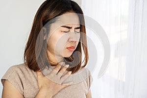 Asian woman suffering from nausea and vomiting, foodborne illness concept photo