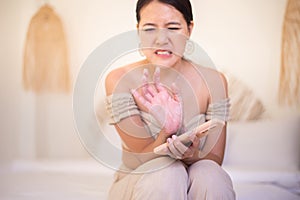 Asian woman suffering from numbness on finger,Numbing pain in hand photo