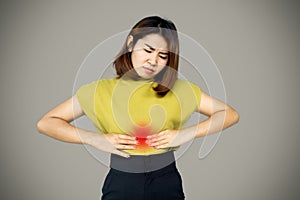 Asian woman suffering from stomach ache, heartburn photo