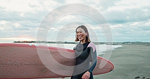 Asian woman, surfboard and happy by ocean, smile and ready for workout, training or wellness in morning. Person, surfer