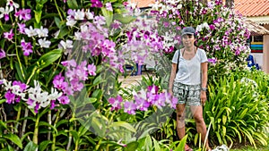 Asian woman surrounded by orchids