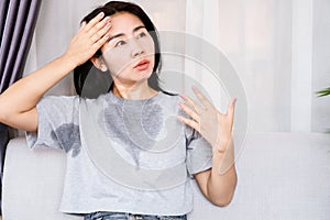 Asian woman sweating because of hot weather, menopause symptom concept