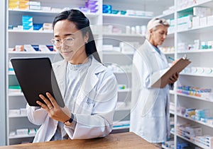 Asian woman, tablet and pharmacist in pharmacy for healthcare, telehealth or stock check. Medicine shop, technology and