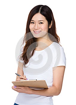 Asian woman take note on clipboard