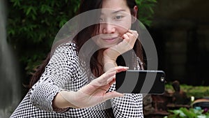 Asian woman take selfie photo in the Garden