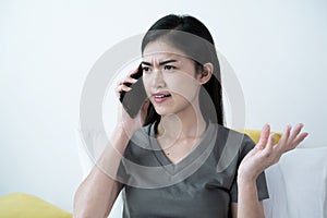 An Asian woman talking on a mobile phone with her friend or boyfriend photo