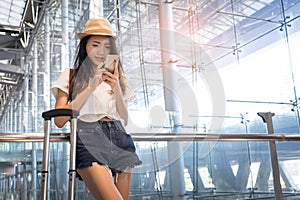 Asian woman teenager using smartphone at airport