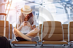 Asian woman teenager using smartphone at airport