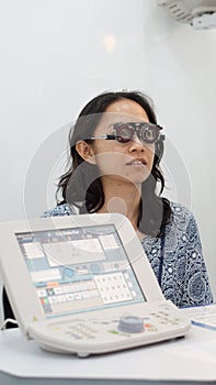 Asian woman test eyesight with professional optometrist for glasses