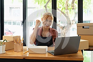 Asian woman think hard serious working laptop computer at home selling online start up small business owner, e-commerce
