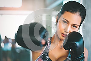 Asian woman throwing Boxing punch into the camera working out for fitness and healthy lifestle