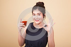 Asian woman thumbs down hate tomato juice.