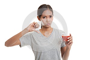 Asian woman thumbs down hate tomato juice.