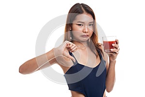 Asian woman thumbs down hate tomato juice.