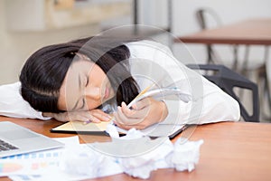 Asian woman with tired overworked and sleep, girl have resting while work writing note