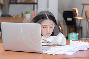 Asian woman with tired overworked and sleep, girl have resting while work writing note,