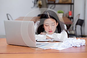 Asian woman with tired overworked and sleep, girl have resting while work writing note,