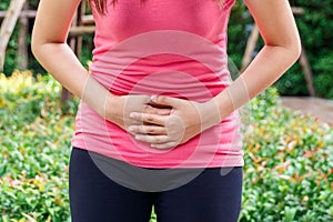 Asian woman touching her own underbelly with stomachache or menses. photo