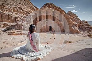 Asian woman tourist sitting in Petra, Jordan