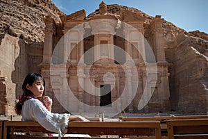 Asian woman tourist sitting in Petra, Jordan