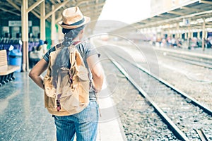 Asian woman tourist standing carrying a backpack. Wait for the train at Hua Lamphong Bangkok Thailand.