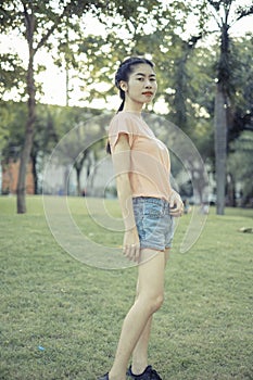 Asian woman tourist traveller backpack watching the beauty of the public park On vacation and relax happily. at Bangkok Thailand