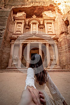 Asian woman tourist holding hand in Petra, Jordan