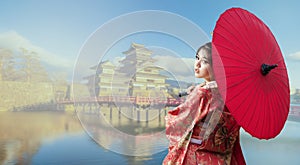 Asian woman tourists. Japanese girl wearing a kimono holding a red umbrella. Beautiful Female wearing traditional japanese kimono