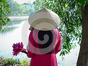 Asian woman in traditional dress with flowers