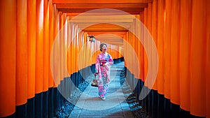 Asian women in traditional japanese kimonos at Fushimi Inari Shrine in Kyoto, Japan