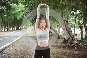 Asian woman trainer is engaged in fitness in public park