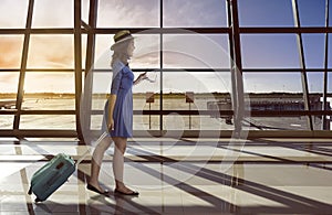 Asian woman travel alone carry suitcase in the airport