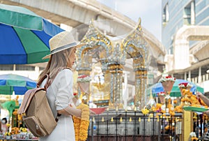 Asian woman travel in erawan shrine Bangkok city