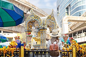 Asian woman travel in erawan shrine Bangkok city