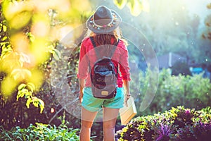 Asian woman travel nature. Travel relax. Study read a book. Nature Education. At public park in summer