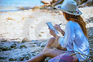 Asian woman travel nature. Travel relax. Study read a book. Nature Education Write a note. On the beach. In the summer. Thailand