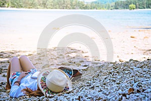 Asian woman travel nature. Travel relax. Study read a book. Nature Education Write a note. Sleep on the beach. In the summer.