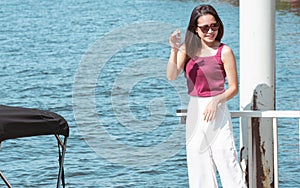 Asian woman travel and waiting for boat near river