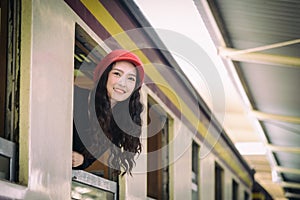 Asian woman traveler has exciting with traveling by train at Hua Lamphong station at Bangkok, Thailand.