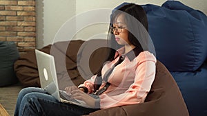 Asian woman typing on the computer.