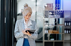 Asian woman typing smartphone, keyboard with laptop computer of.Social media and Marketing virtual icons screen concept