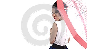 Asian woman with an umbrella with polka dots pattern lookin at camera on white background.