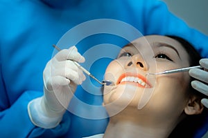 Asian Woman undergo check up of tooth in dental clinic photo