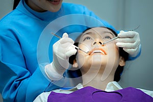 Asian Woman undergo check up of tooth in dental clinic