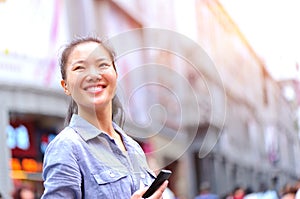 Asian woman use cellphone at shopping street